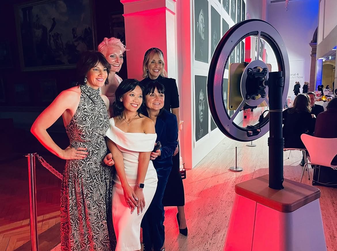 Elegant gala event with guests posing beside the Robo Booth robotic photo booth